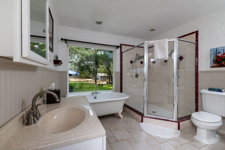 Bathroom with clawfoot tub and walk-in shower at 1311 Mount Gilead Rd, Keller TX