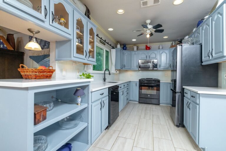 Kitchen with quartz countertops and painted cabinetry at 1311 Mount Gilead Rd, Keller TX
