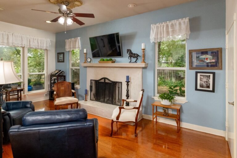 Living room with wood-burning fireplace at 1311 Mount Gilead Rd, Keller TX
