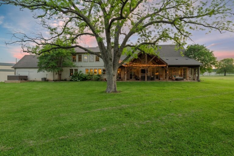 Back of the home with covered patio and mature trees at 1331 Bancroft Road, Keller TX