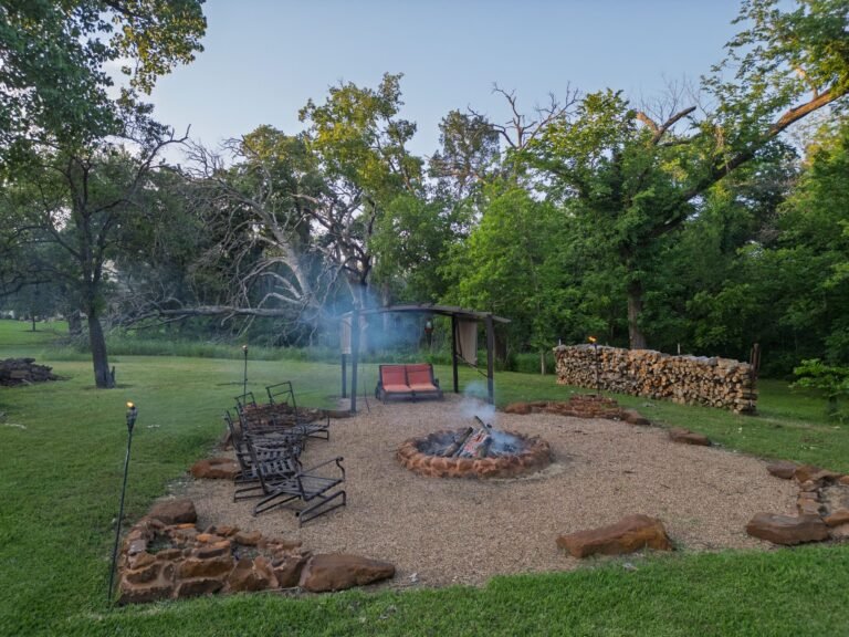 Fire pit seating area under the trees at 1331 Bancroft Road, Keller TX