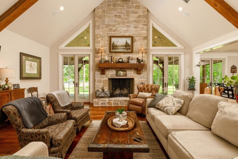 Vaulted living room with stone fireplace and exposed beams at 1331 Bancroft Road, Keller TX