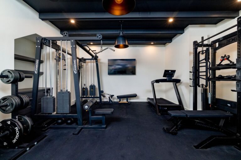 Home gym with rubber flooring and dark beamed ceiling at 1412 Chelsea Rae Lane, Keller TX