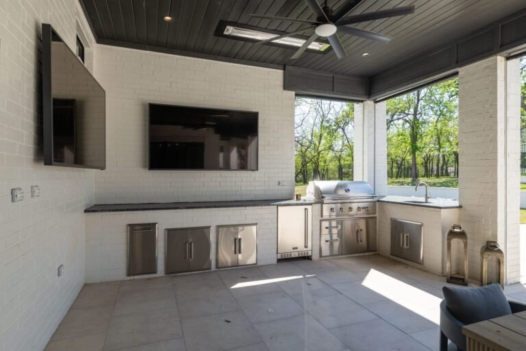 Covered outdoor living area with outdoor kitchen and TV at 1412 Chelsea Rae Lane, Keller TX