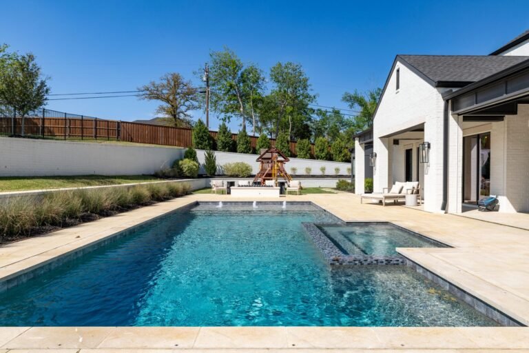 Pool and raised spa with travertine decking at 1412 Chelsea Rae Lane, Keller TX