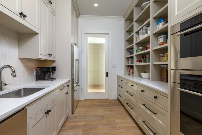 Walk-through prep pantry with sink, second oven, and open shelving at 1412 Chelsea Rae Lane, Keller TX