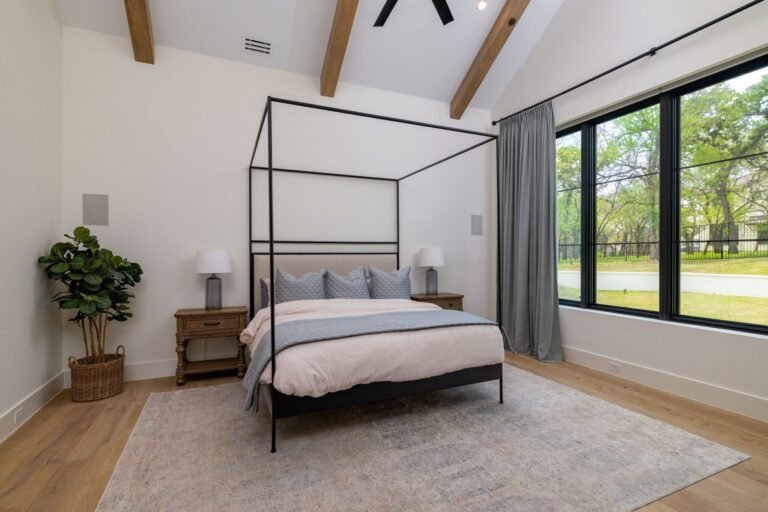 Downstairs primary bedroom with beamed vaulted ceiling at 1412 Chelsea Rae Lane, Keller TX